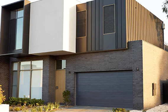 Modern home exterior with sectional Gliderol garage door and Colorbond steel cladding